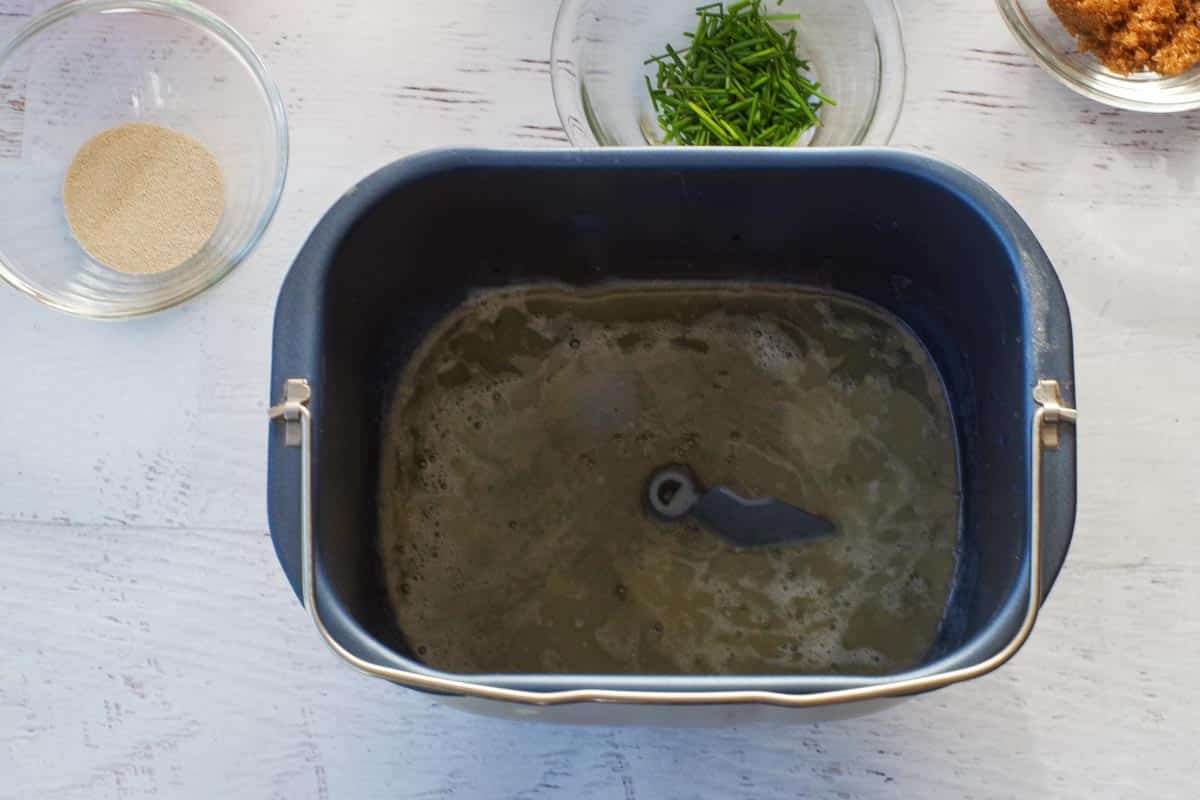 Beer and melted butter added to the bread machine loaf pan.