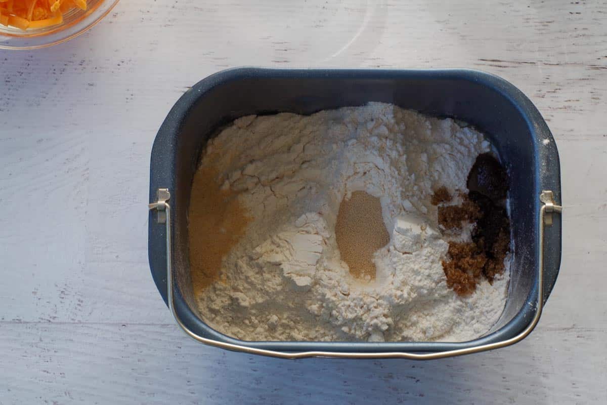 Dry ingredients added to the loaf pan on top of liquid ingredients.