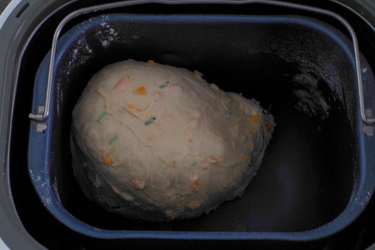 Beer, Cheese and Chives bread dough in loaf pan after adding cheese and chives.