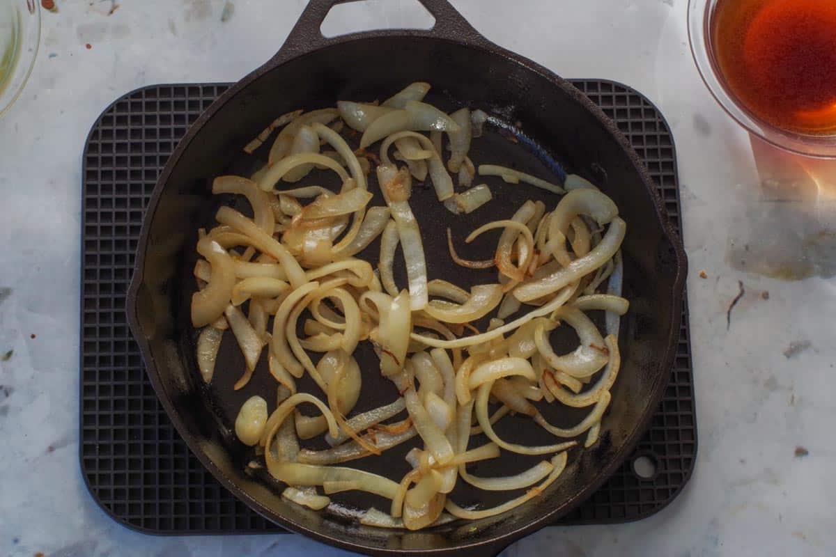 Onions for Healthy Salisbury Steak gravy sauteed in cast iron pan.