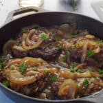 Grilled healthy Salisbury Steak with Beer and Onion Gravy in a cast iron pan