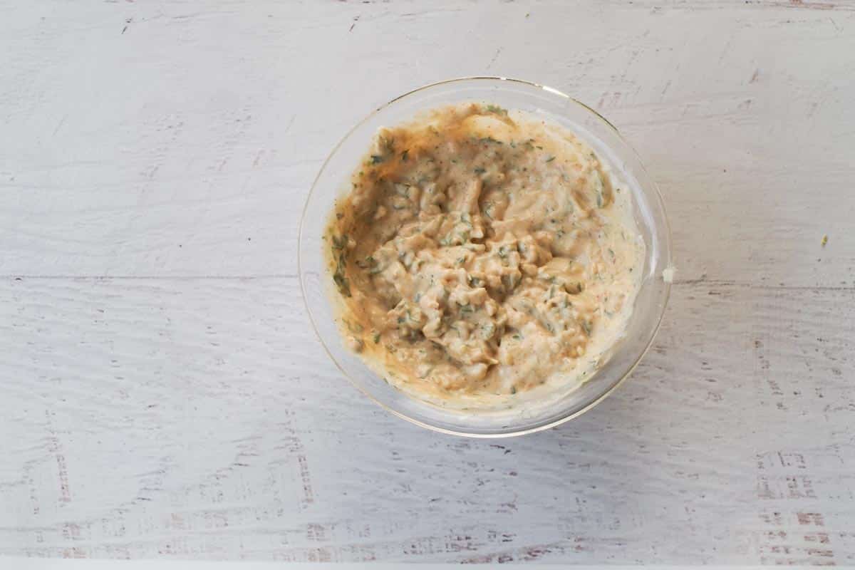 Sauce ingredients mixed together in a glass bowl.