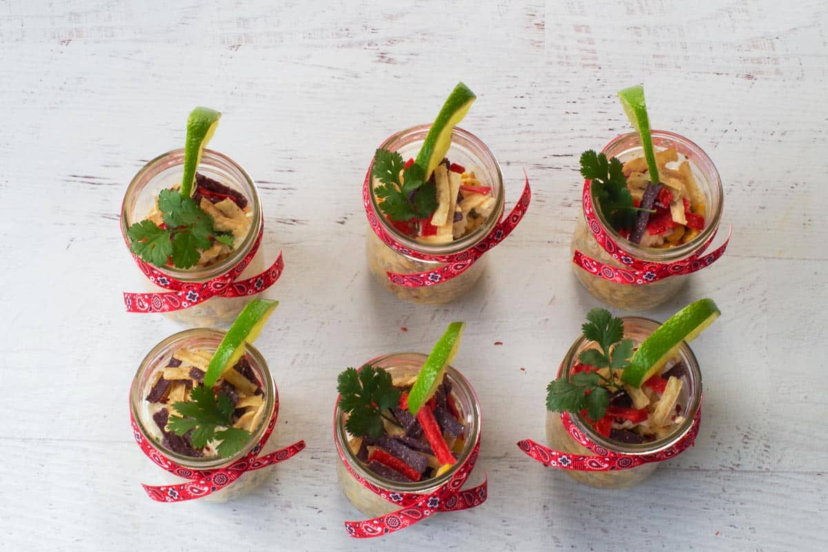 Lime and cilantro added to jars as garnish.