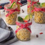 Stampede Street Corn Cup with a denim napkin beside it and 5 more corn cups in the background.