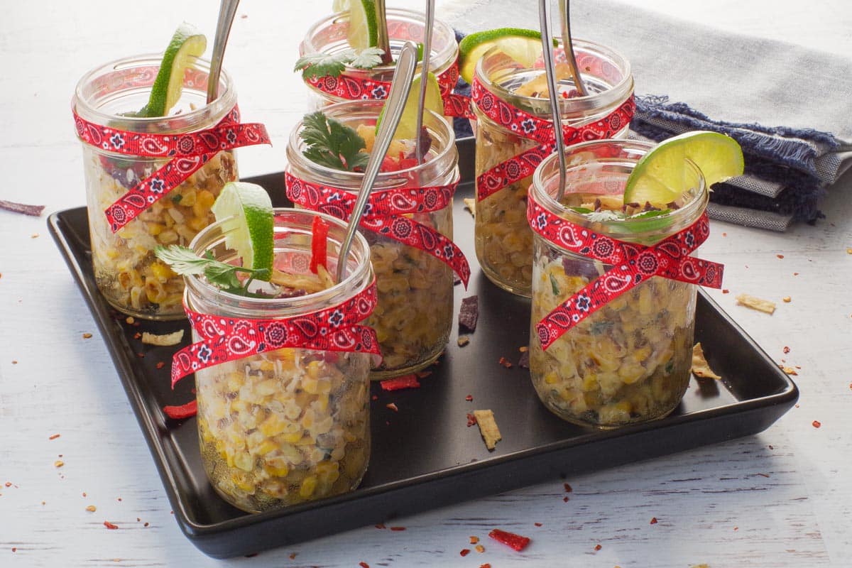 6 Stampede Street Corn Cups on a black tray.