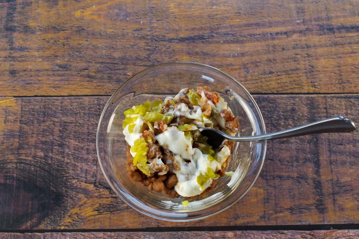 Maple Baked Bean Aioli ingredients mixed together in medium glass bowl.