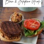 Maple Baked Bean Aioli on a hamburger, with more on the side and maple baked beans in the background.