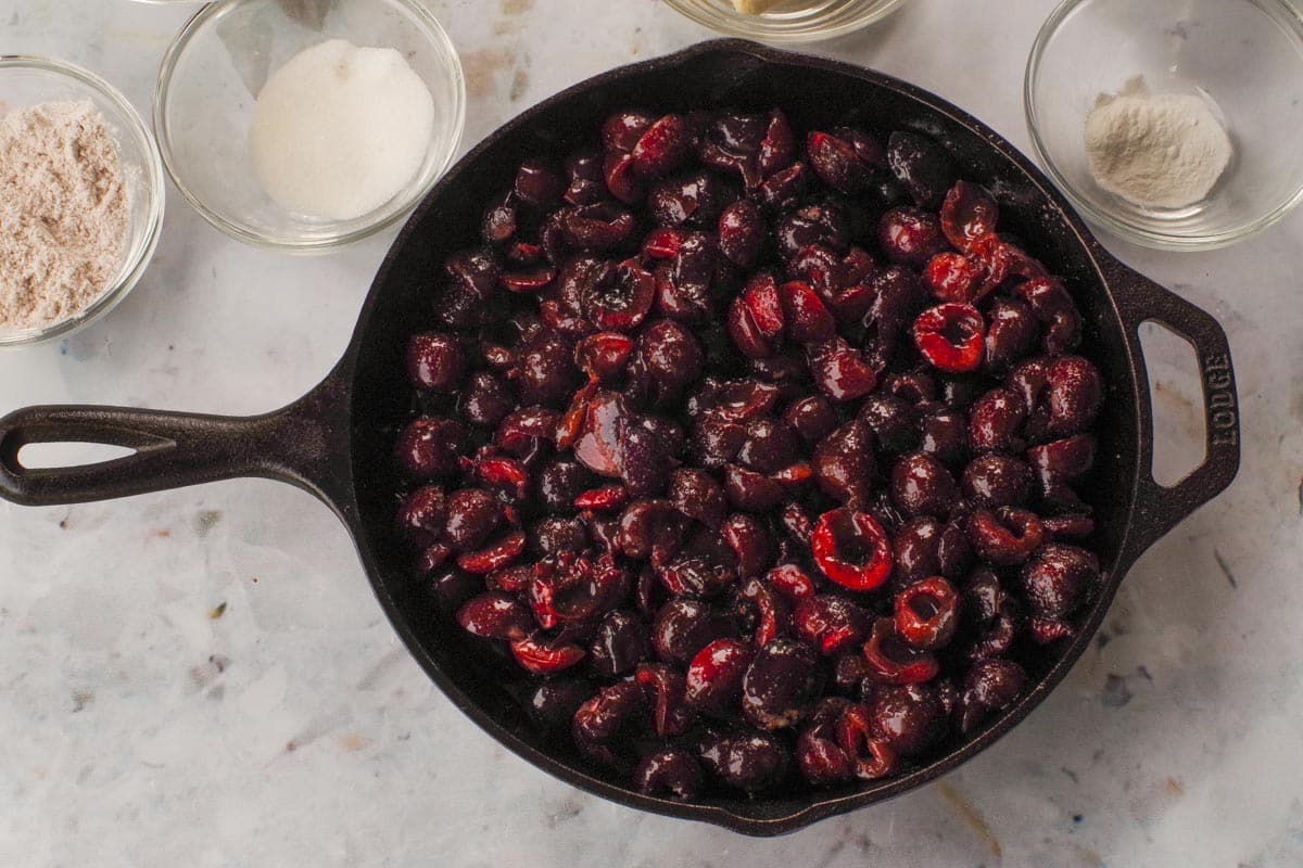 Cherry mixture poured into a cast iron frying pan.