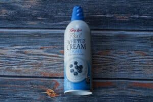 A spray can of whipped cream for Healthy Overnight Black Forest Oats.