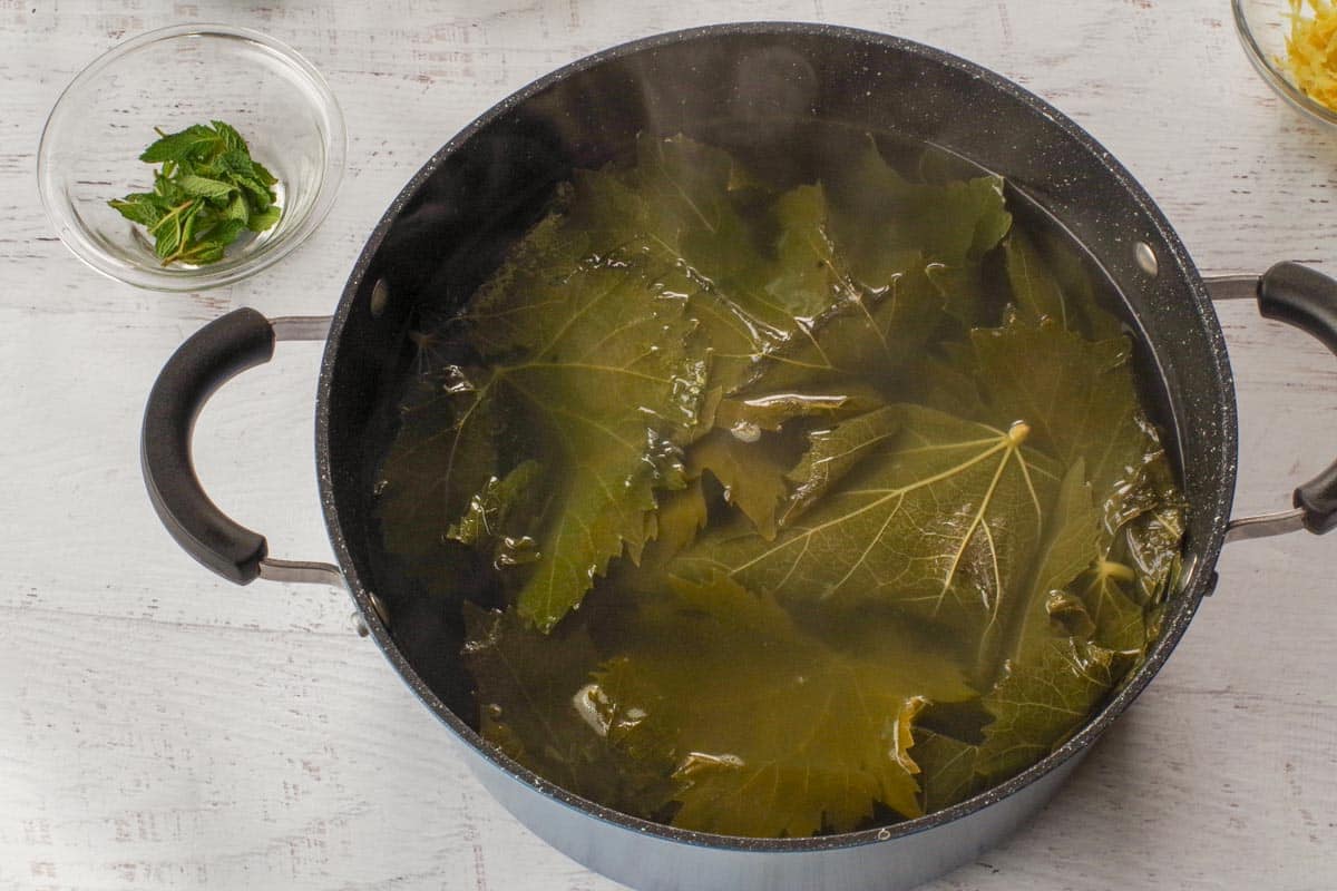 Grape leaves cooking in a pot.