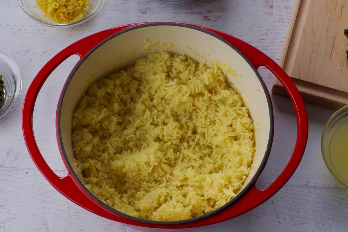 Mint and lemon added to rice mixture in Dutch oven.
