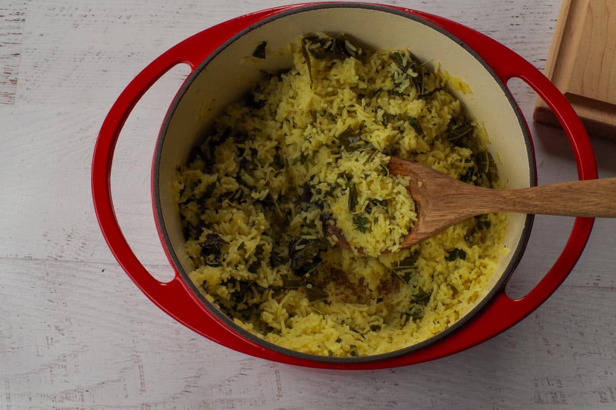 Chopped grape leaves added to the rice mixture in Dutch oven.