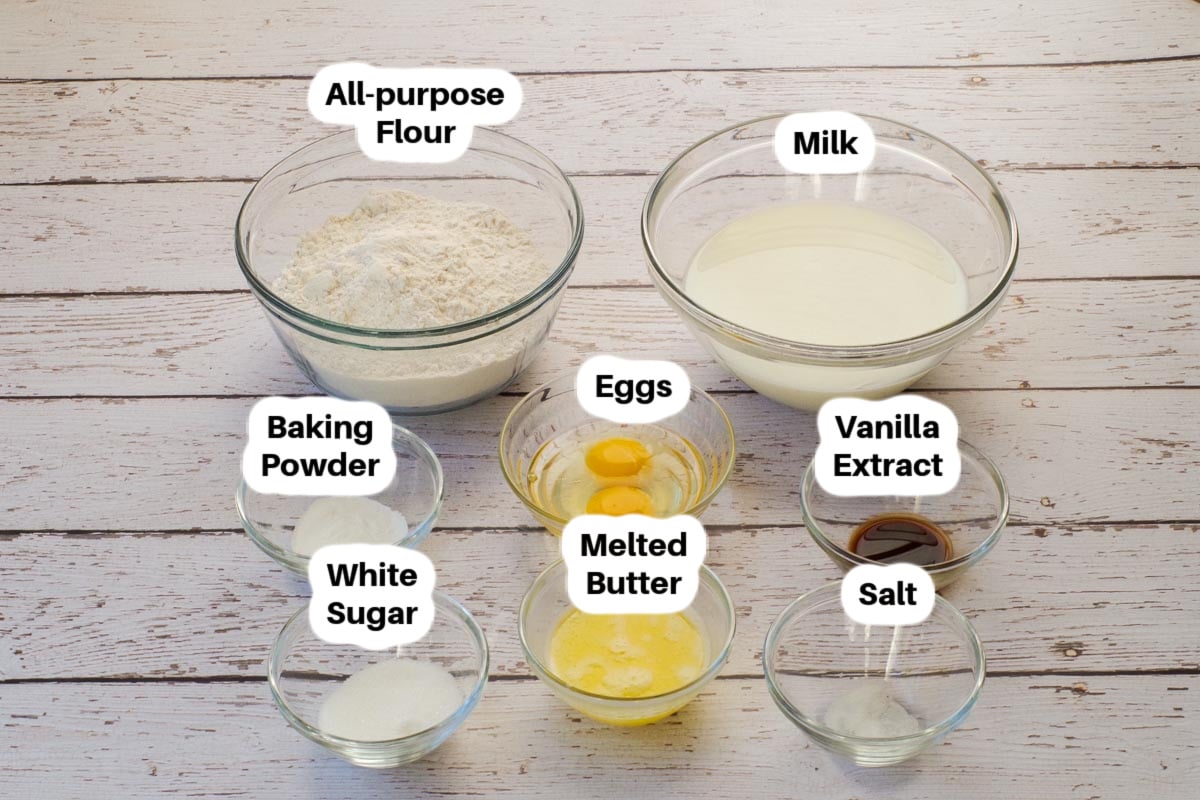 Ingredients needed for old fashioned oven baked pancakes in glass bowls, labelled,