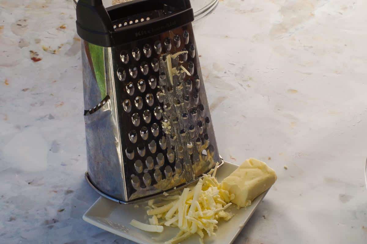 Frozen butter grated through the large holes of a cheese grater.