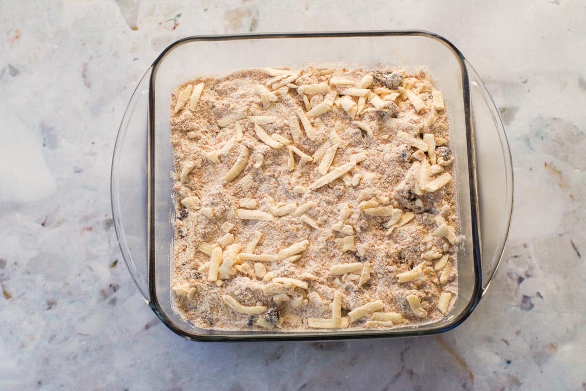 Topping spread evenly over berry and whipped cream mixture in square glass baking pan.