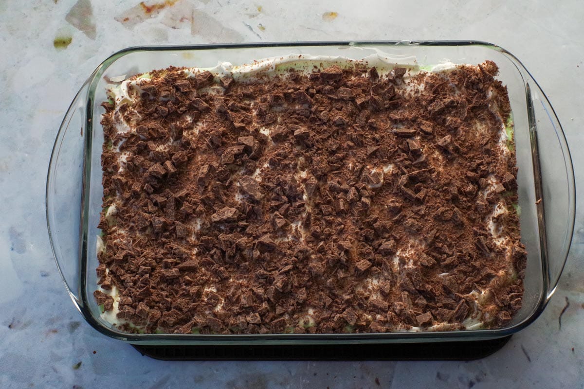 Finely chopped chocolate bars sprinkled over whipped cream layer.