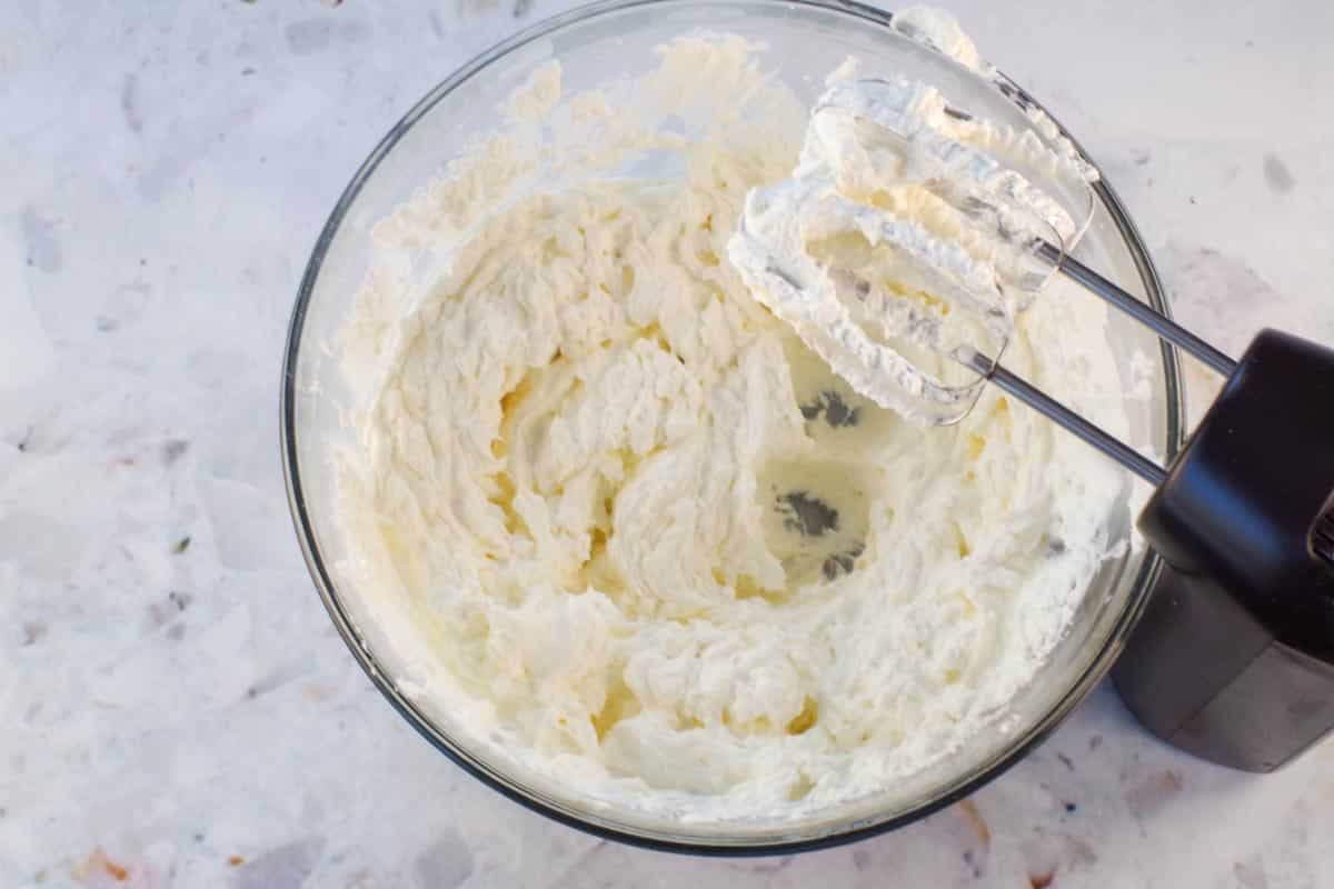 Whipped cream beaten to stiff peaks with 2 tbsps of powdered sugar