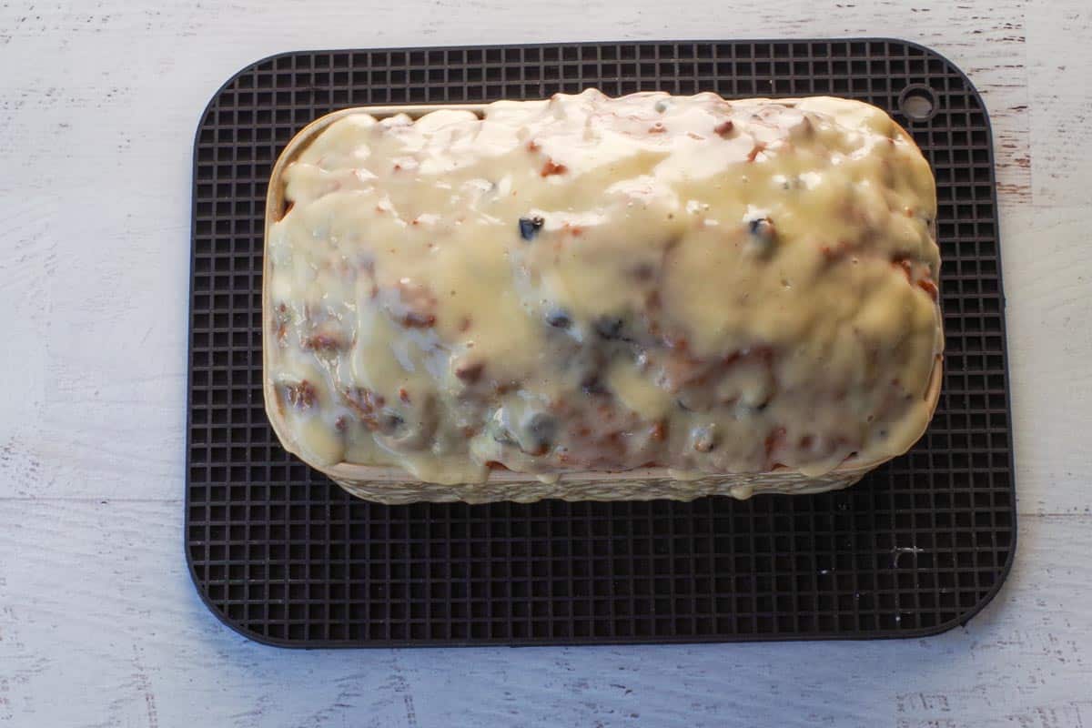 Glaze poured over Saskatoon Berry Loaf in pan.