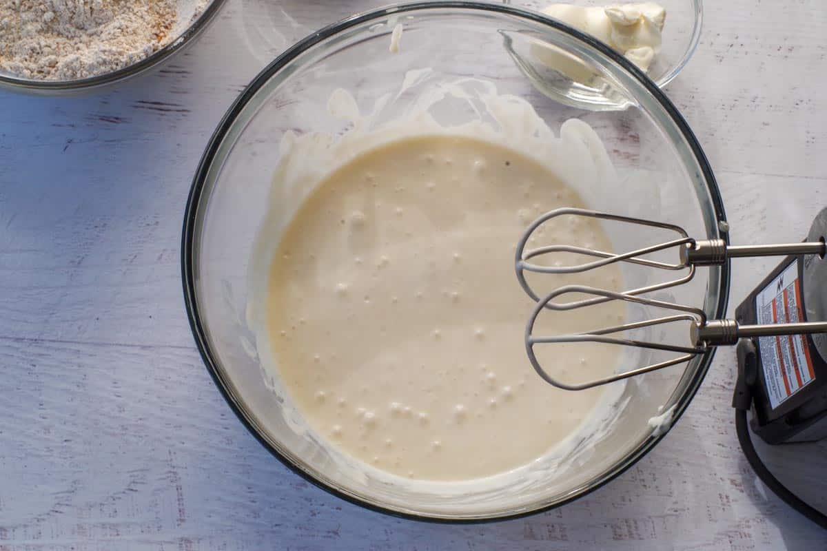 Wet ingredients added to egg and beaten together in a large glass bowl.