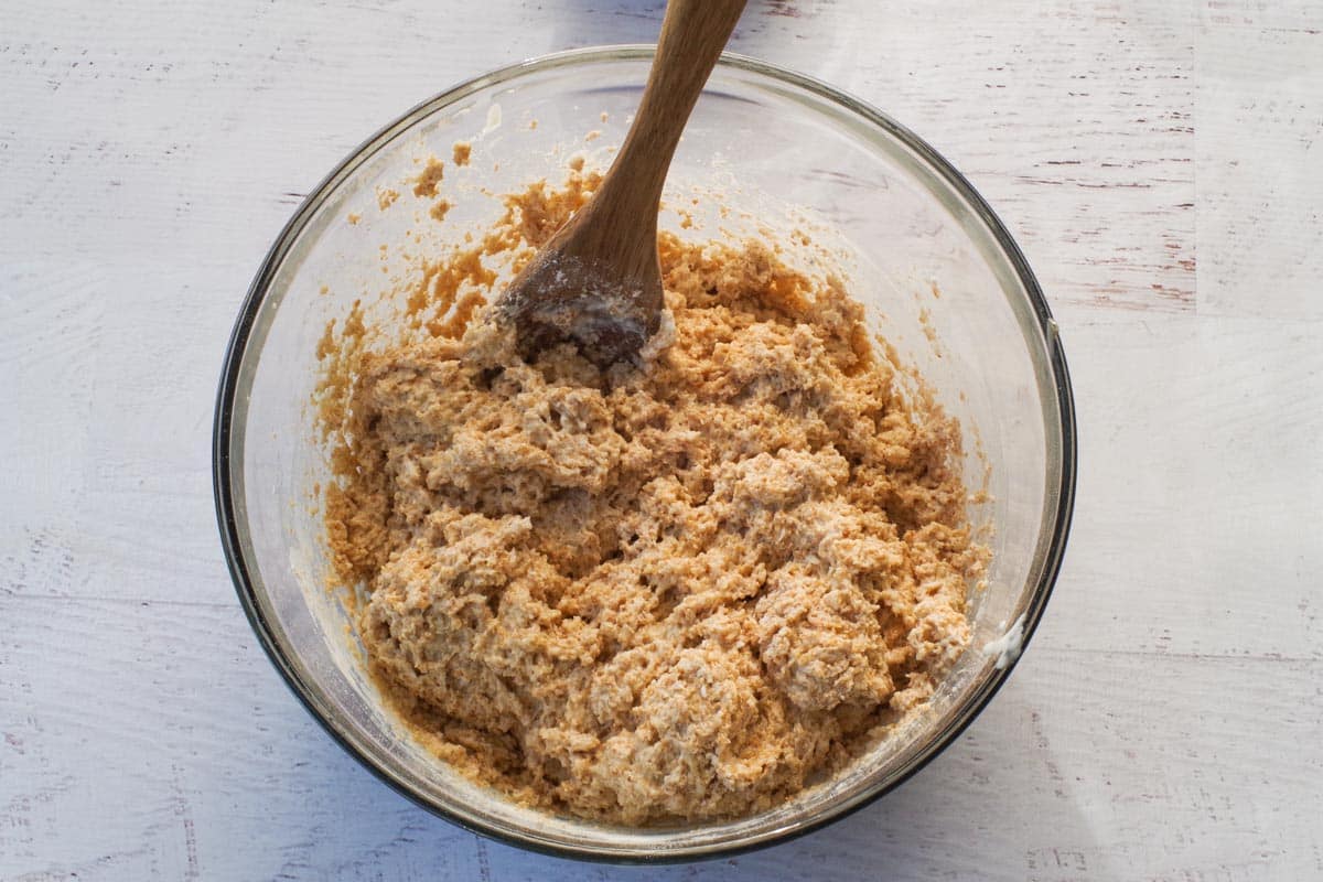 Flour mixture added to wet mixture in large glass bowl.