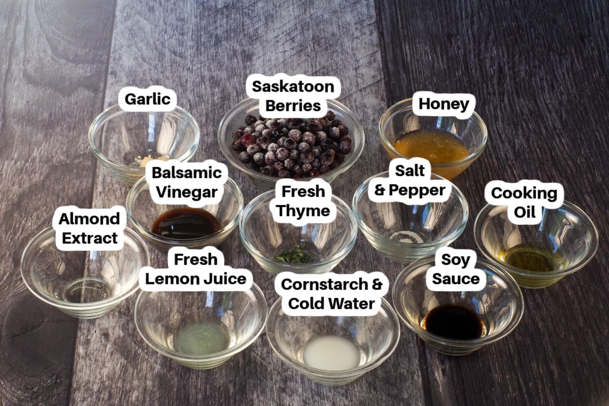 Ingredients in Savory Saskatoon Berry Sauce (for meat) in glass bowls, labelled.