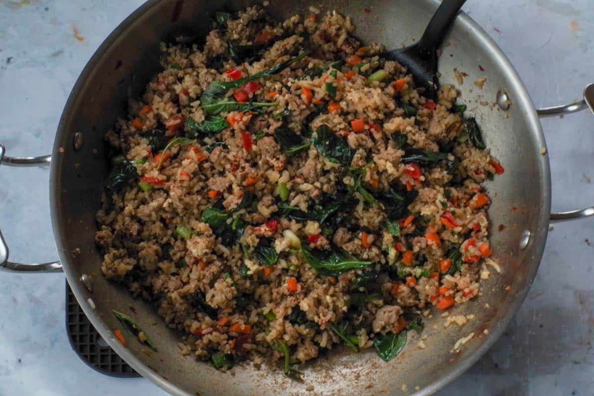 Basil added to mixture and wilted after stirring.
