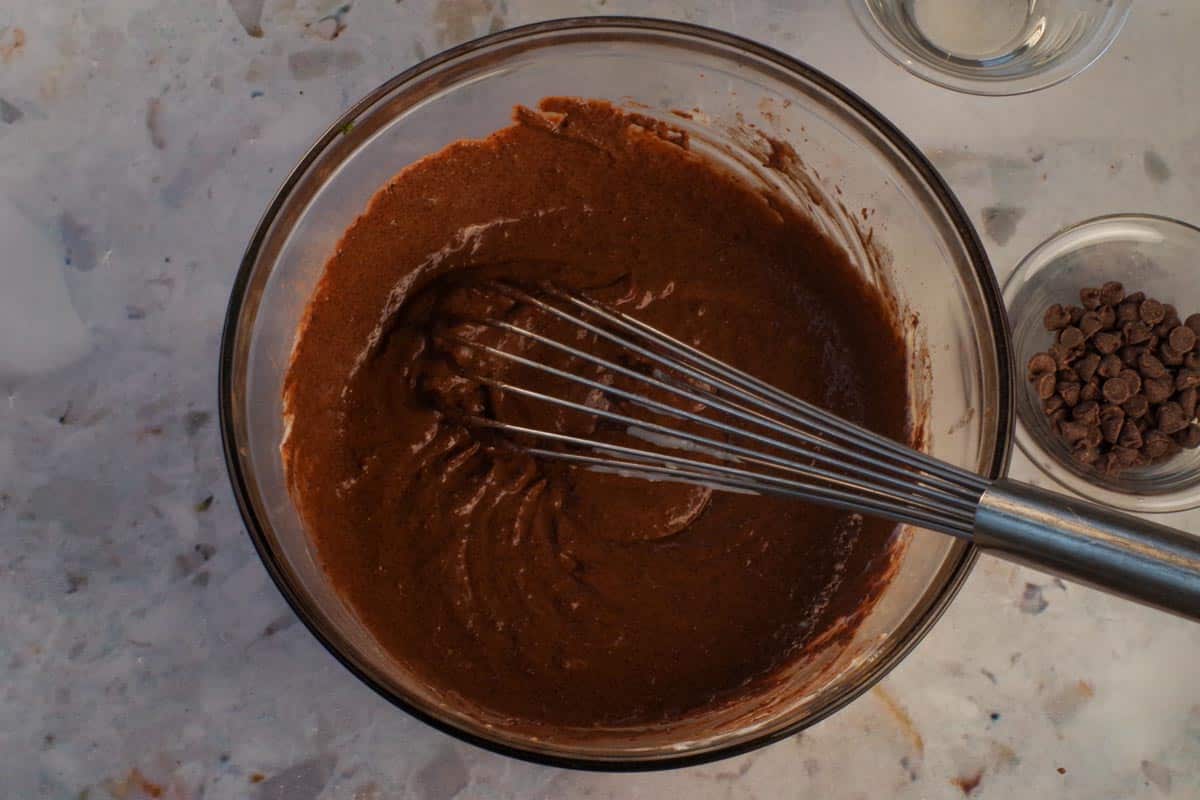 Wet ingredients whisked into sugar/cocoa mixture in large glass bowl, with whisk.