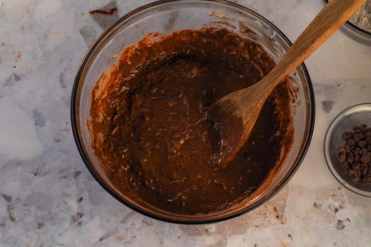 Finely grated zucchini stirred into the mixture with a large wooden spoon.