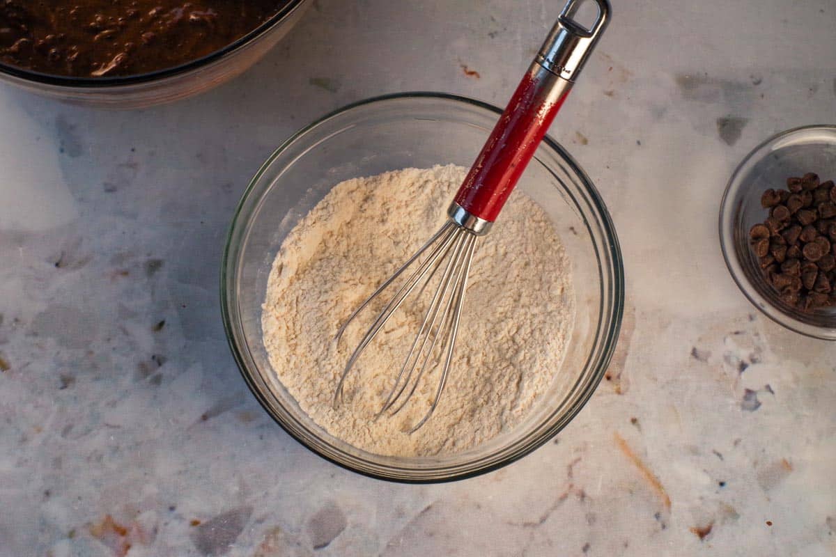 Dry ingredients whisked together in a medium glass bowl.