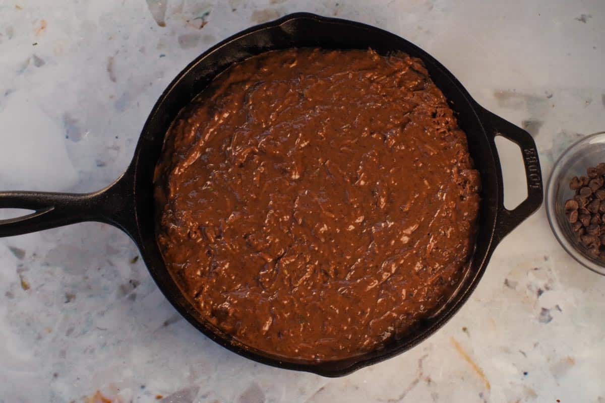 Cake batter poured into prepared pan (cast iron frying pan)
