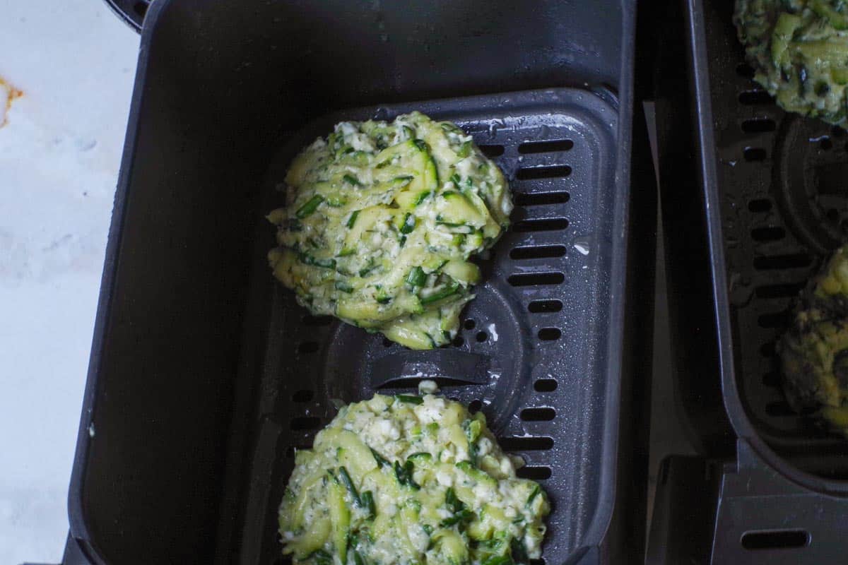 Patties placed in air fryer drawers.
