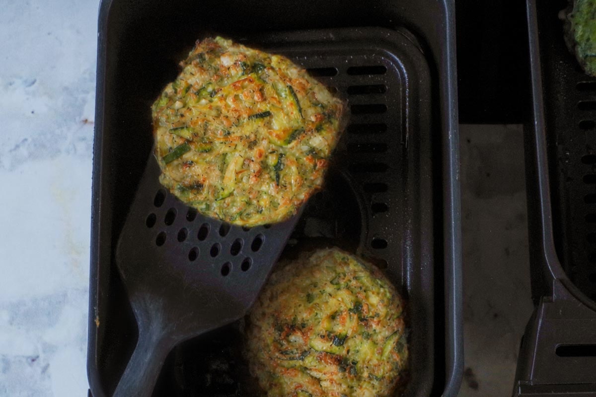 Zucchini Fritter air fried on both sides in Ninja air fryer drawer.