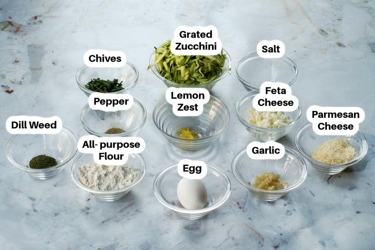 Mediterranean Air Fryer Zucchini Fritters ingredients in small glass bowls, labelled.
