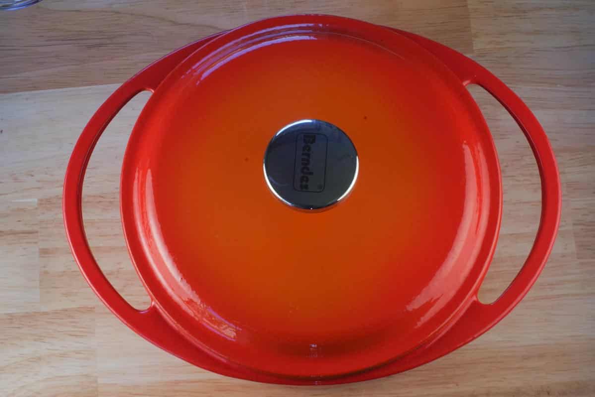 Orange Dutch oven with lid on.