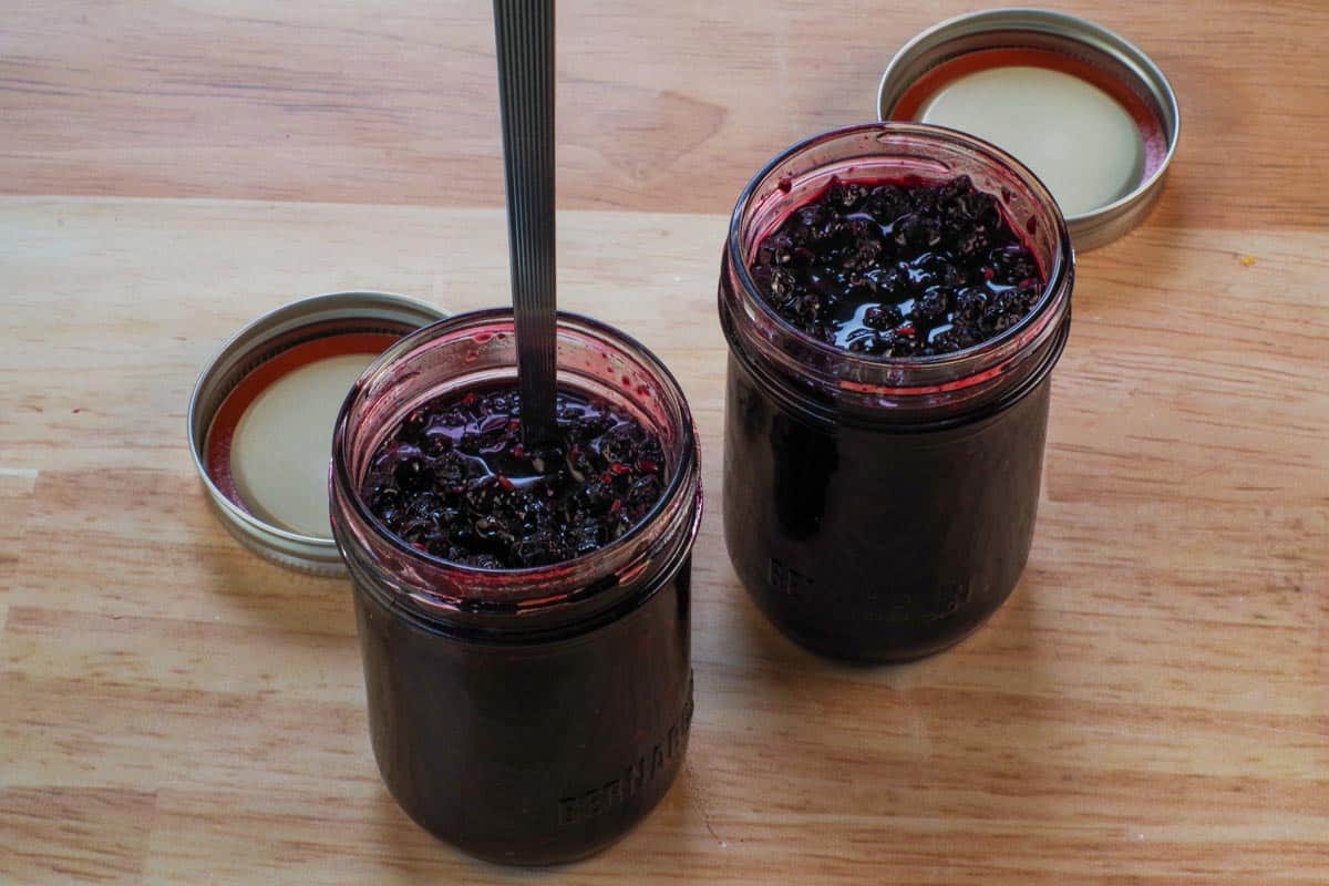 Hot jam ladled into sterile jars.