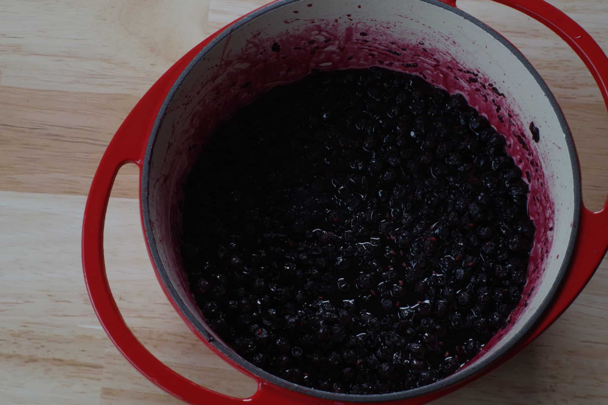 Cooked Saskatoon berry jam in a Dutch oven.