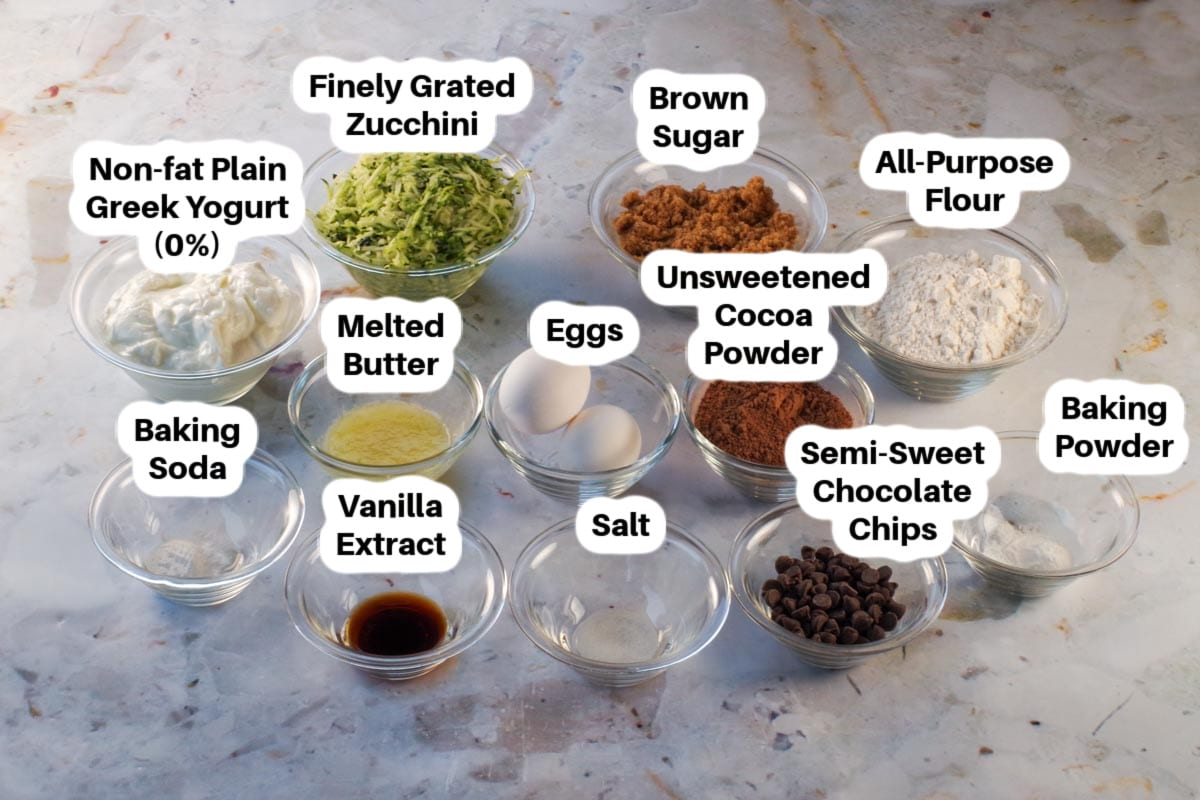 Ingredients in Chocolate Zucchini Spoon Cake in small glass bowls, labelled.