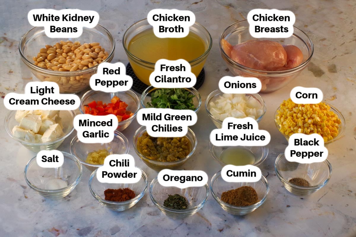 Ingredients in Crockpot White Chicken Chili in glass bowls, labelled.