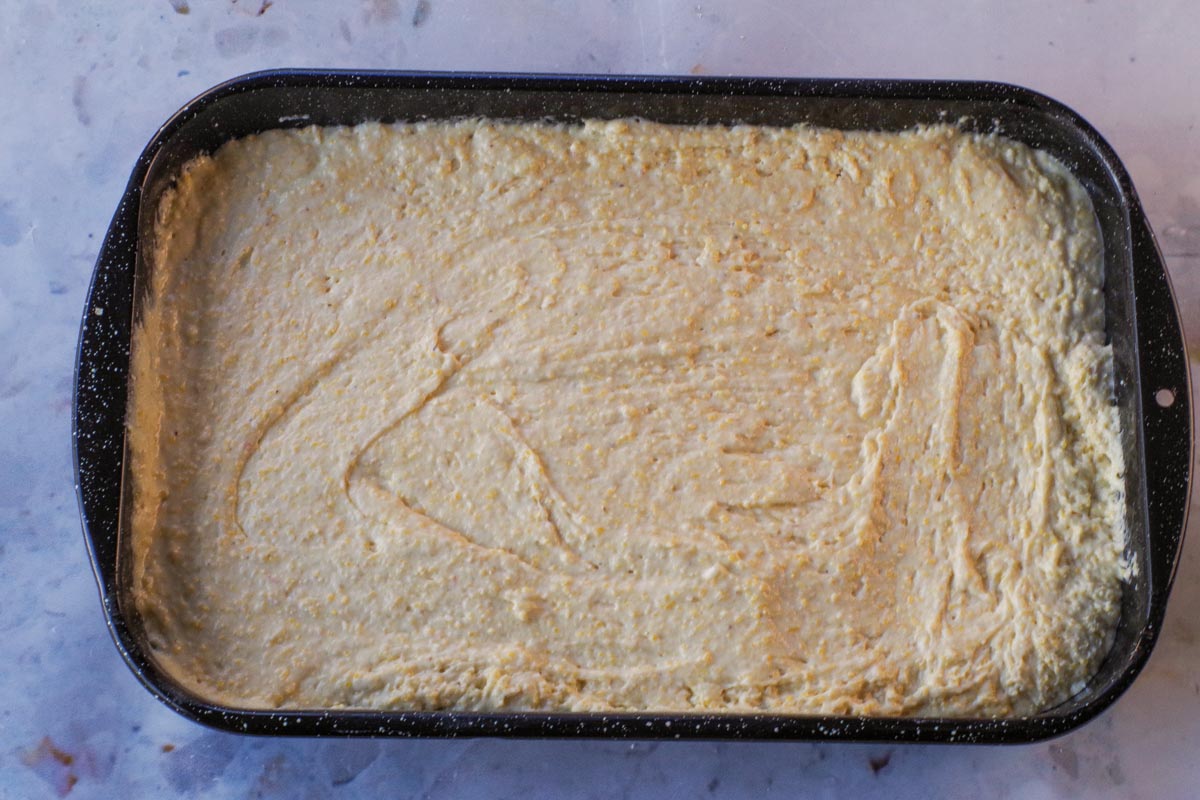 Cornbread batter poured into prepared pan,