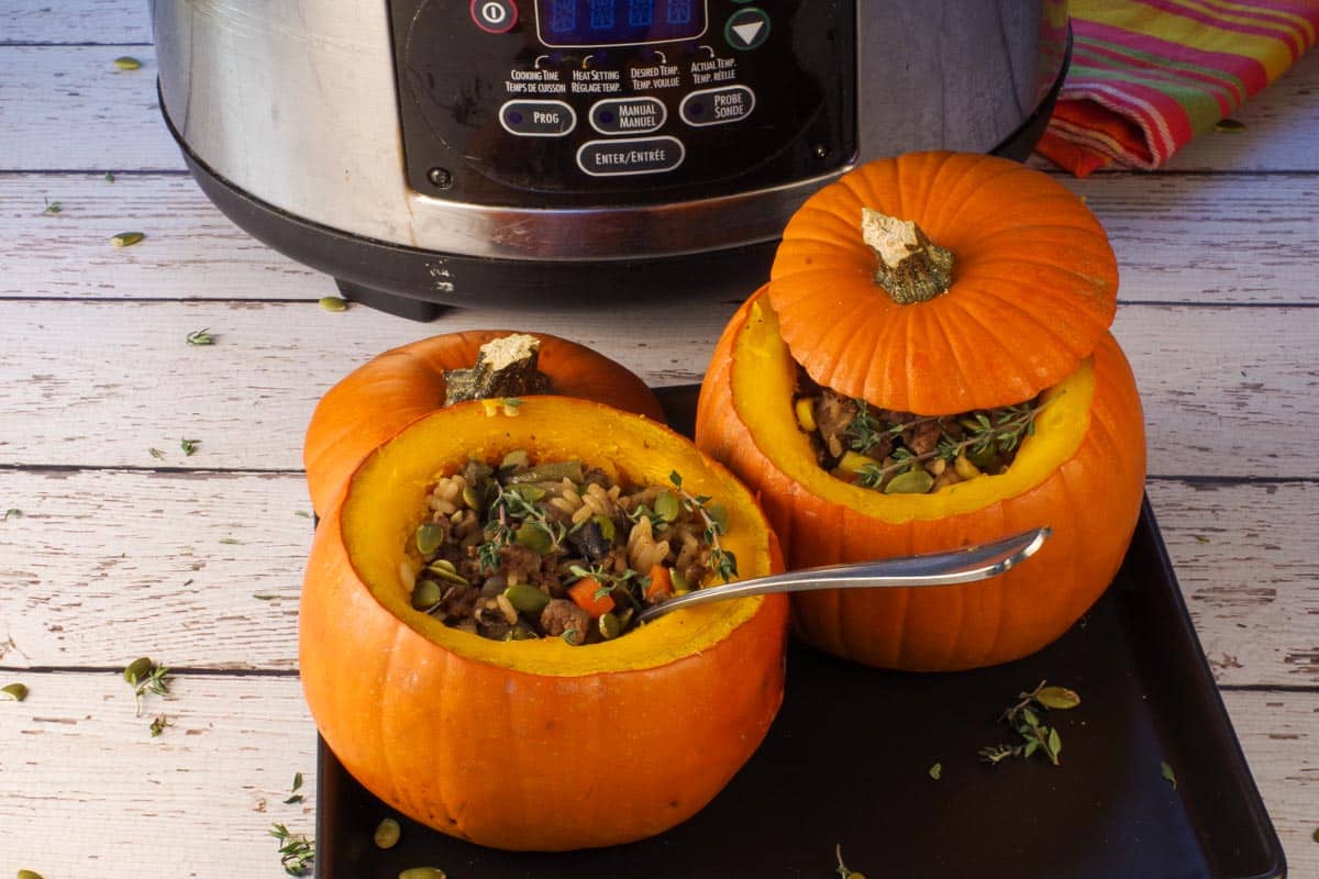 2 Dinner in a Pumpkins in front of a slow cooker.